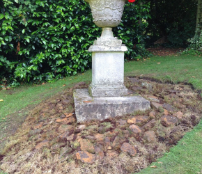Renovated elderly urn - simply planted with a brilliant red Pelargonium